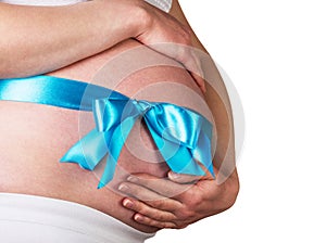 Pregnant woman with blue bow isolated on white.