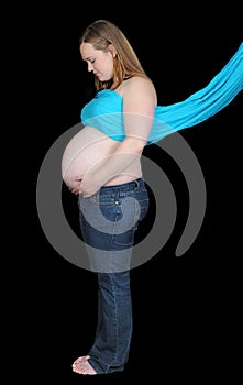 Pregnant woman in blue drape looking down