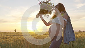 Pregnant woman with a bouquet of wildflowers