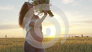 Pregnant woman with a bouquet of wildflowers