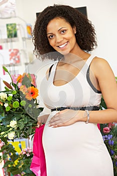 Pregnant woman buying flowers