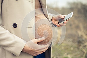 Pregnant woman calling by mobile phone