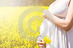 Pregnant woman in canola field