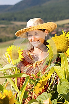 Pregnant woman in cap standing on field