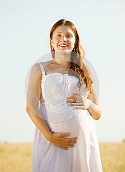 Pregnant woman in cereal field