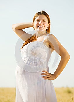 Pregnant woman in cereal field