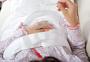 Pregnant woman checking her body temperature