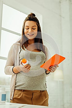 Pregnant woman checking the safety of the medicine