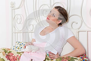Pregnant woman with children's clothes.