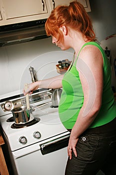 Pregnant woman cooking