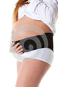 Pregnant woman with corset photo