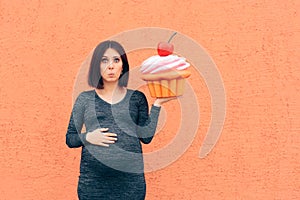 Pregnant Woman Craving Sweets Holding Huge Cupcake