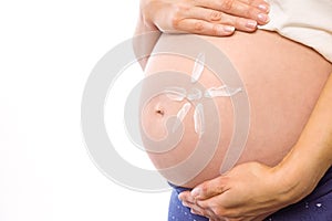 Pregnant woman with cream on bump