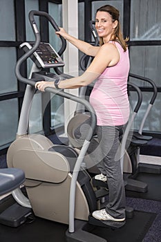 Pregnant woman on crosstrainer