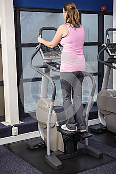 Pregnant woman on crosstrainer