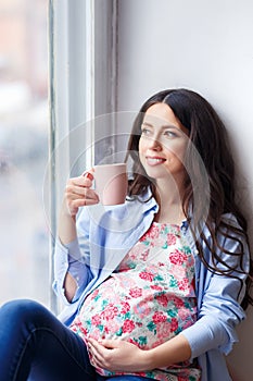 Pregnant woman with cup of tea