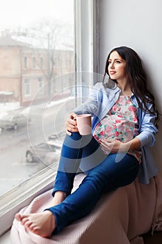 Pregnant woman with cup of tea