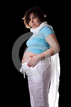 Pregnant woman on dark background with white and b