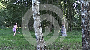 Pregnant woman with daughter girl play badminton game in park