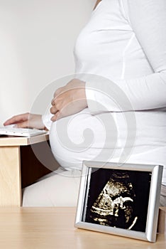 Pregnant woman at desk - ultrasound