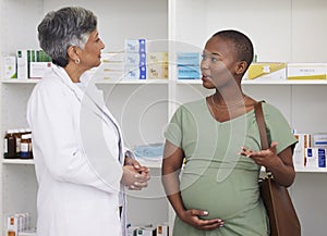 Pregnant woman, doctor and consultation at pharmacy for checkup or healthcare advice at drug store. African person in
