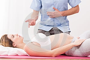 Pregnant woman doing breathing exercise