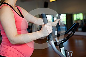 Pregnant woman doing cardiovascular exercise photo