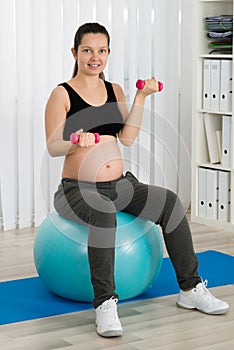 Pregnant Woman Doing Exercise On Fitness Ball