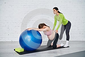 A pregnant woman is doing exercises