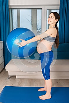 Pregnant woman doing exercises with fit ball