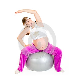 Pregnant woman doing exercises on fitness ball