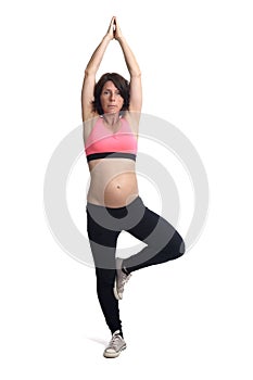 Pregnant woman doing exercises on white background