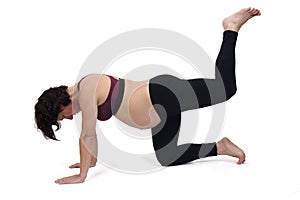 Pregnant woman doing exercises on white background,