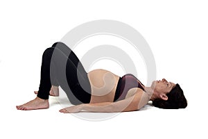 Pregnant woman doing exercises on white background,