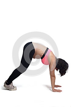 Pregnant woman doing floor exercises on white background