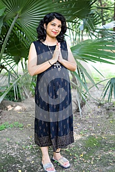 Pregnant woman doing Pregnancy yoga pose comfortable at society park with belly, Pregnant woman practicing simple yoga steps at