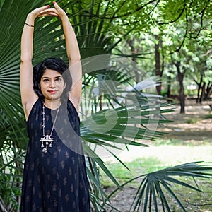 Pregnant woman doing Pregnancy yoga pose comfortable at society park with belly, Pregnant woman practicing simple yoga steps at