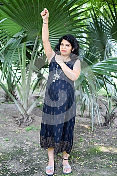 Pregnant woman doing Pregnancy yoga pose comfortable at society park with belly, Pregnant woman practicing simple yoga steps at