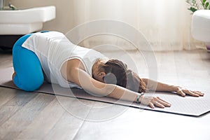 Pregnant woman doing prenatal Child Yoga Pose at home photo