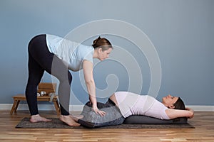 Pregnant woman doing prenatal yoga in Baddha Konasana or Purna Titli