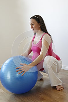 Pregnant woman doing squatting exercise