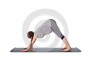 Pregnant woman doing yoga asana Adho mukha svanasana