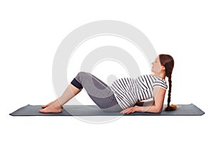 Pregnant woman doing yoga asana Purvottanasana