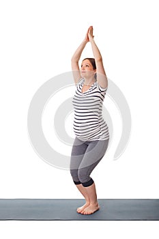 Pregnant woman doing yoga asana utkatasana