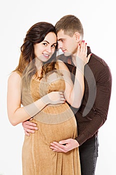 Pregnant woman in dress holds hands on belly isolated on white background. Family and couple expecting baby pregnancy