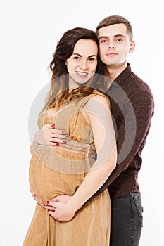 Pregnant woman in dress holds hands on belly isolated on white background. Family and couple expecting baby pregnancy