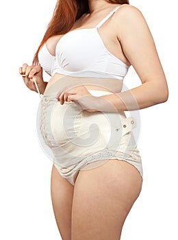 Pregnant woman dressing obstetrical binder photo