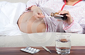 Pregnant woman drink some syrup and pills