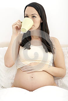 Pregnant woman drinking coffee