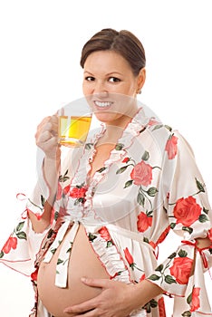 Pregnant woman is drinking tea